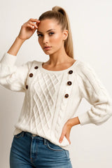 White cable-knit sweater styled with light-wash jeans, chic casual look