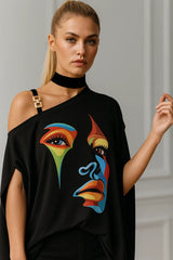 Black asymmetrical top with colorful artistic face print – trendy women’s fashion statement piece
